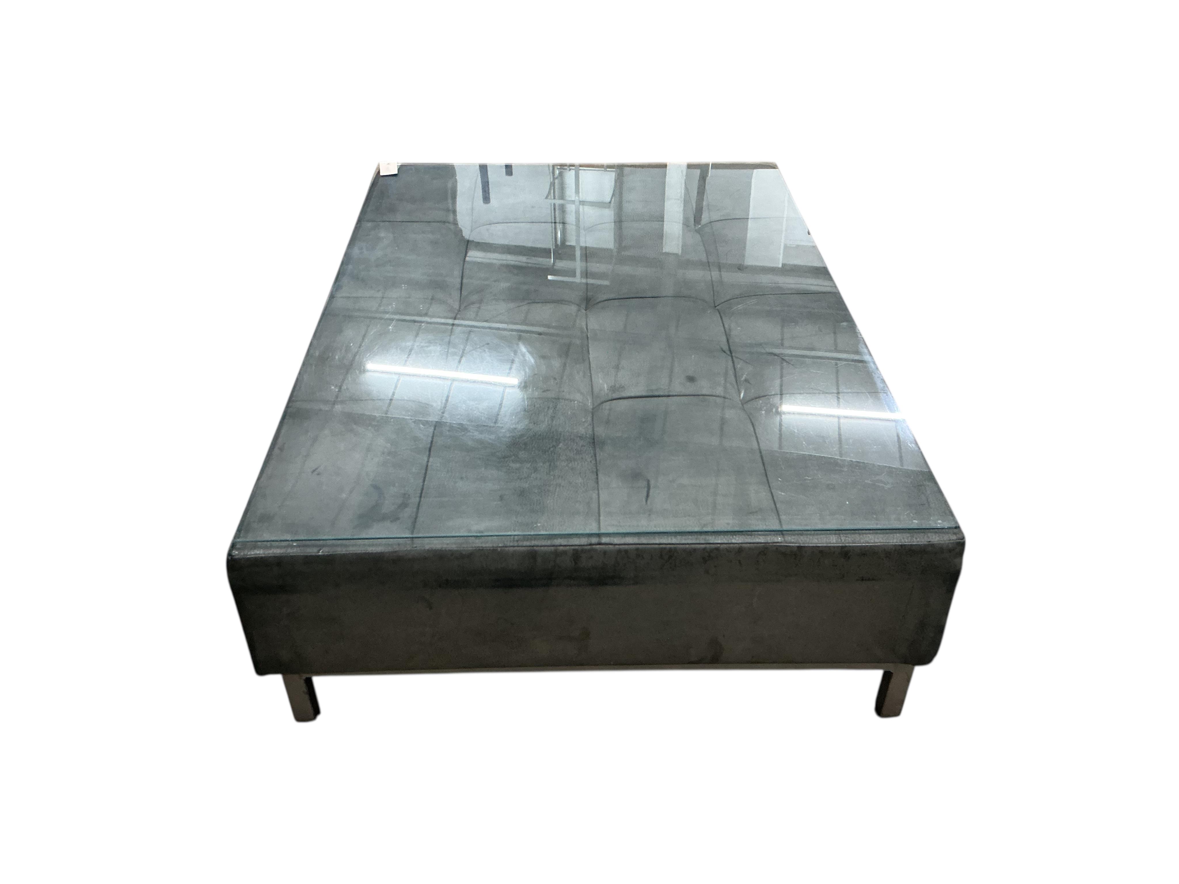 A contemporary leather rectangular ottoman stool with plate glass top, width 124cm, depth 88cm, height 34cm